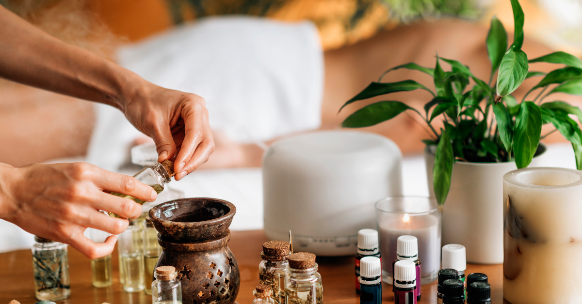a set of different oils in glass jars to be mixed together on a wooden table for relaxation mood