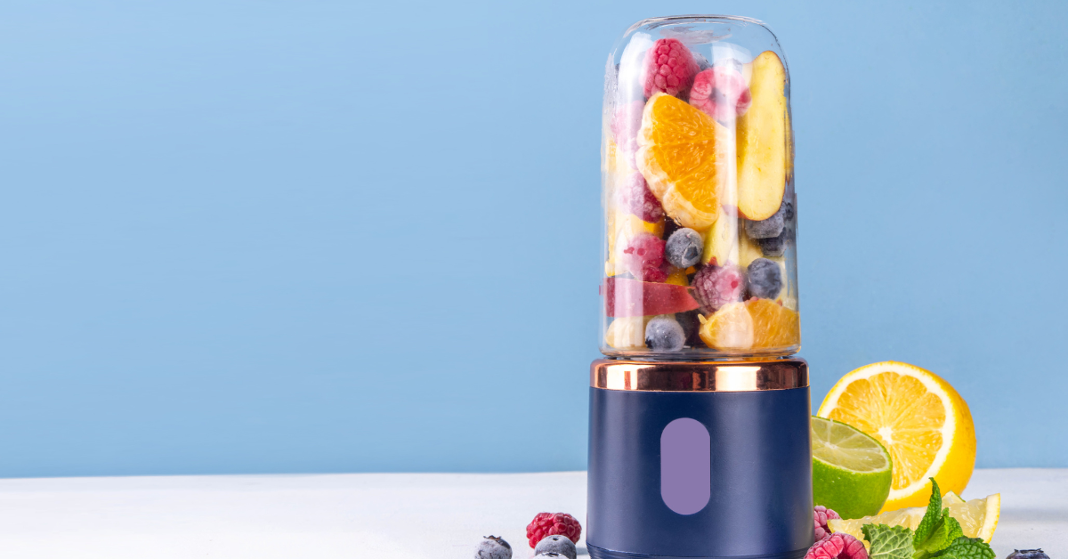 a portable blender with frozen fruit inside, waiting to be blended.